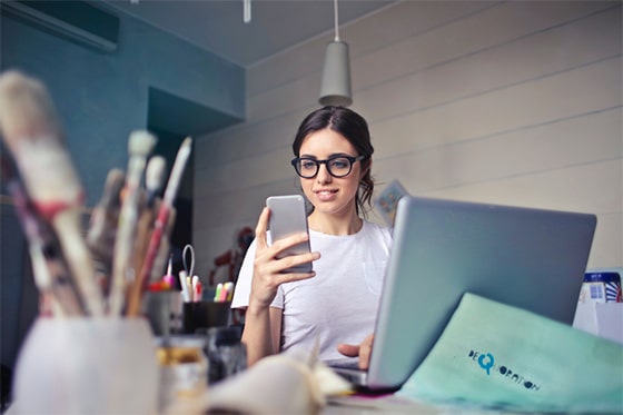 A woman reads an article on her phone about how to improve your mental health with technology