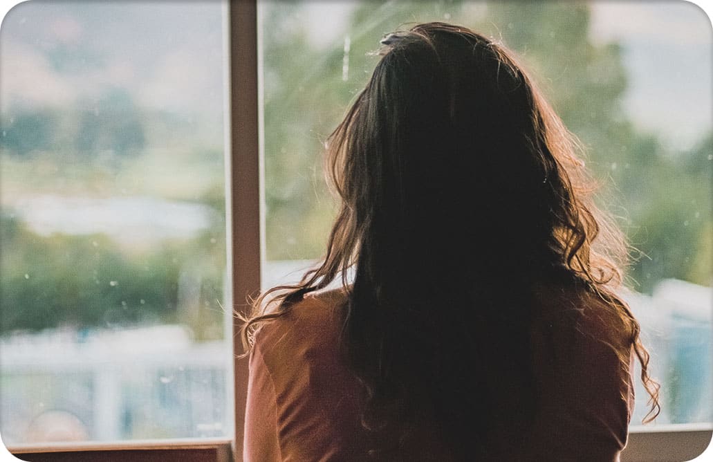 woman looking out of window